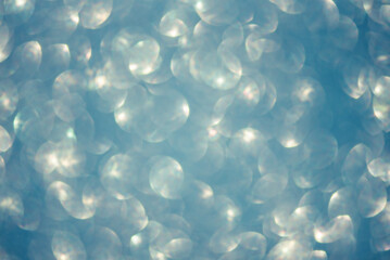 Blue glitter defocused background. Abstract blurred blue background.