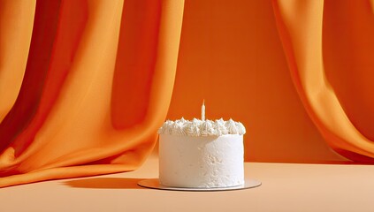 Single white cake with a single candle on a light beige surface, soft orange background