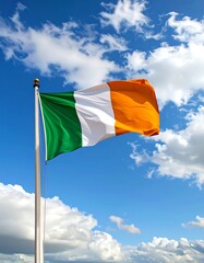 Irish flag waving in a partly cloudy sky
