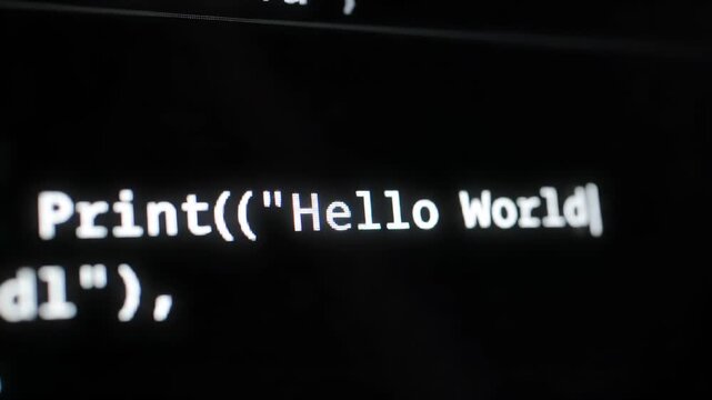 Close-up of white programming code displayed on a black digital screen. The text is sharp, with the background slightly blurred, suggesting focus on the code's content.