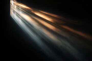 Light rays streaming from a window into a dark room