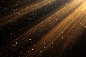 Golden light rays with glitter particles on a dark background