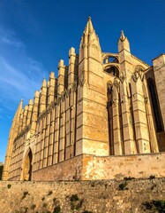 Ancient stone cathedral facade under a clear blue sky