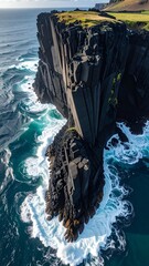 Dramatic cliff face meeting churning ocean waves