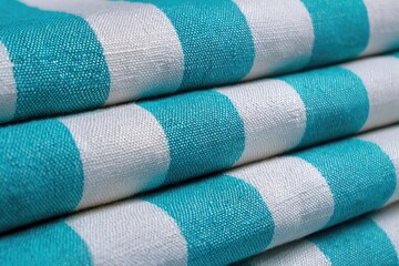 Close-up of folded teal and white striped fabric