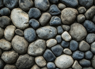 Stone background. Wall of rounded pebbles.