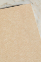 neutral pattern beige hardcover book texture on white marble table