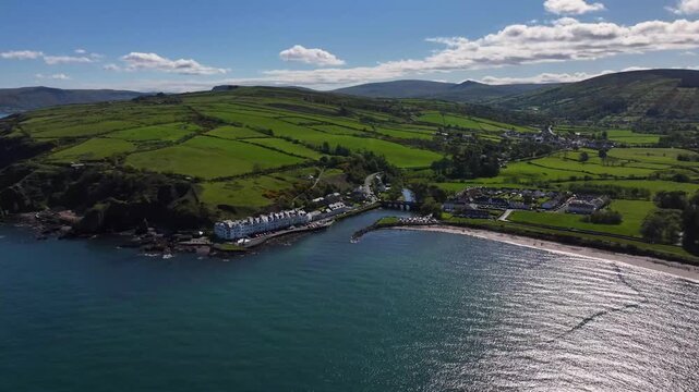 Aerial Drone shot of Cushendun village Glendun on the Irish Sea County Antrim Northern Ireland on a sunny day with a blue sky 