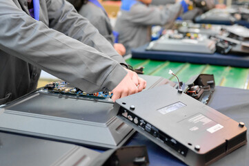 Installation of flex cables and connectors at a television assembly plant for final product assembly in a manufacturing facility