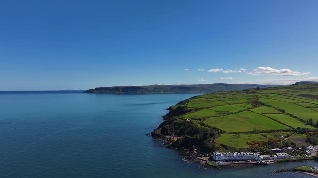 Aerial Drone shot of Cushendun village Glendun on the Irish Sea County Antrim Northern Ireland on a sunny day with a blue sky 