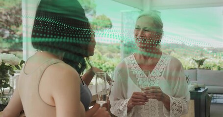 Senior woman pointing on terrace, guests raising flutes toasting bride-to-be at bridal shower