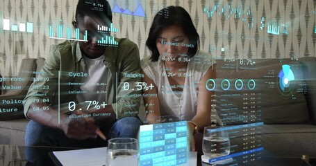 Couple opening finance report reading numbers noting as transparent chart overlay guiding planning - Powered by Adobe