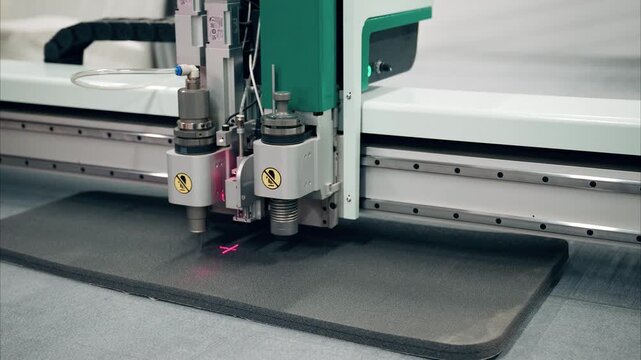 Precision cutting of foam rubber using industrial plotter in a creative workspace