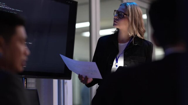 An AI engineer presents a new machine learning algorithm. She is explaining the Python code and the neural network architecture during a tech conference keynote or a project demo.