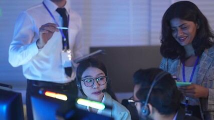 A team of engineers call center in a Network Operations Center collaborates on a critical alert, with a lead engineer guiding them through system diagnostics on a late night shift. - Powered by Adobe