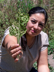 Woman Working in a Vegetable Garden with Fresh Produce