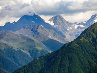 Fototapeta premium mountains and clouds. mountain, landscape, mountains, sky, nature, snow, alps, panorama, view, clouds, peak, summer, travel, valley, high, alpine, green, cloud, forest, panoramic, scenery, grass, rock