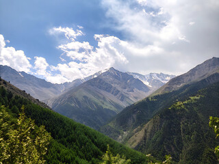 Naklejka premium mountains in the mountains. mountain, landscape, mountains, sky, nature, summer, clouds, alps, travel, panorama, snow, valley, view, peak, green, forest, cloud, alpine, hill, panoramic, scenery, hikin