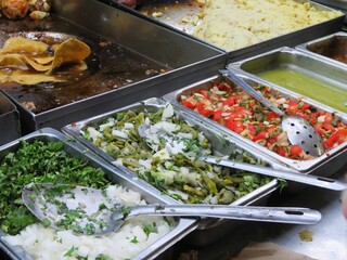 traditional mexican taco filling station in a street, including opuntia, pico de gallo, salsas, tortilla, onion