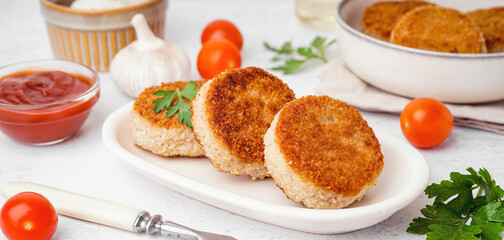 Plate of tasty meat cutlets on white background