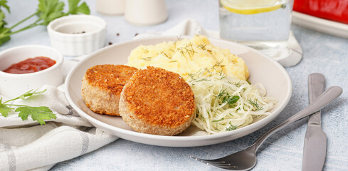 Plate of tasty meat cutlets with mashed potatoes and salad on white background