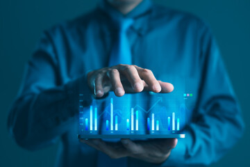 Businessman using tablet with digital bar chart interface for business data analysis, smart performance tracking and financial growth technology