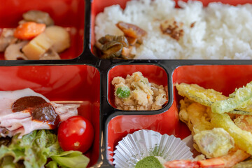 bento lunch set includes a variety of dishes, vegetables and Japanese sweets.