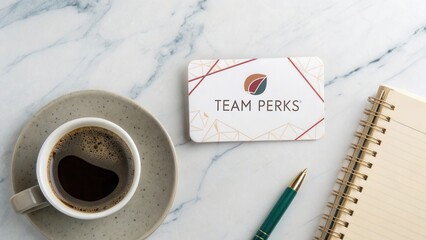 Elegant coffee cup, stylish notebook, and reward card on marble surface showcasing productivity and team spirit in work environment