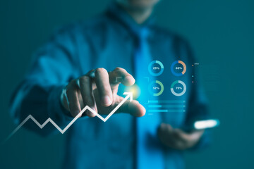 Businessman pointing at rising growth chart with financial analytics, data visualization, performance metrics, and progress strategy for success in digital business technology