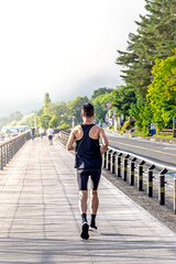 man in sports clothing jogging in park