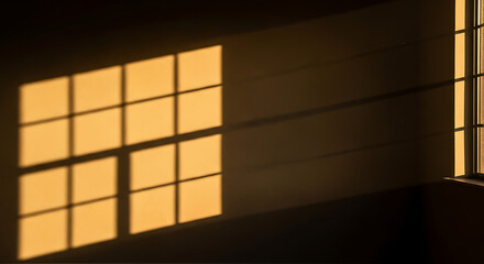 Fototapeta premium Golden hour light rays through window creating dramatic shadows on empty wall — moody and cinematic