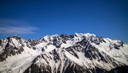 Celestial Serenity: Jagged Snowy Peaks Under a Deep Blue Starry Sky