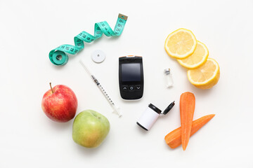 Glucometer with glucose sensor, insulin and fruits on white background. Diabetes concept