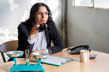 Young lawyer or businesswoman sending audio message with a cellphone