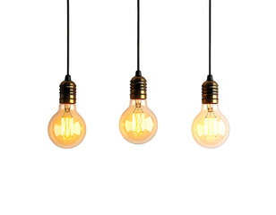 Three incandescent light bulbs hang from dark cords against a black background, warm light glowing inside