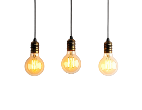 Three incandescent light bulbs hang from dark cords against a black background, warm light glowing inside