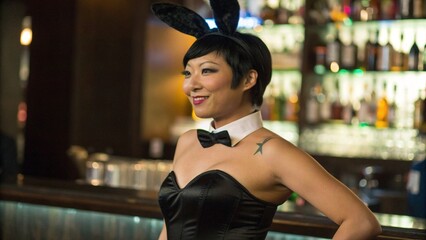 Close Up of Asian Woman in Black Bunny Girl Costume with Tattoo Behind Bar Counter
