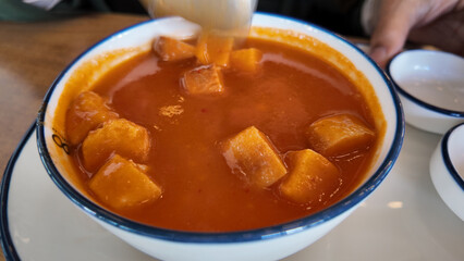 Traditional soup with thick potato cubes in a bowl