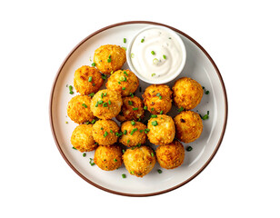 Crispy, golden-brown bite-sized balls atop a plate, with a side of creamy sauce