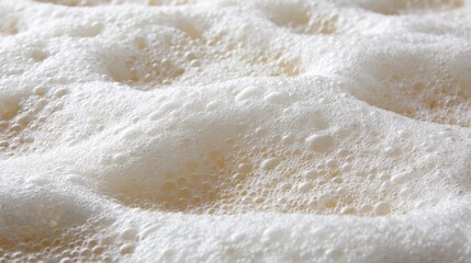Obraz premium Close-up View of Frothy Beverage Surface Showcasing Intricate Bubbles and Textures in a Warm Light Setting