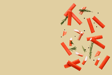 Tasty crab sticks with rosemary and peppercorns flying on green background © Pixel-Shot