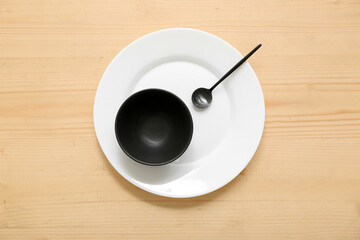 Table setting in white and black colors on wooden background