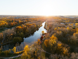 Aerial view of Montreals Angrignon park and urban forest at sunset near cityscape. g.