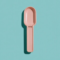 A pale pink measuring spoon against a teal background