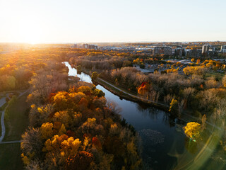 Aerial view of Montreals Angrignon park and urban forest at sunset near cityscape. g.