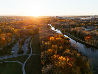 Aerial view of Montreals Angrignon park and urban forest at sunset near cityscape. g.
