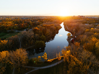 Aerial view of Montreals Angrignon park and urban forest at sunset near cityscape. g.