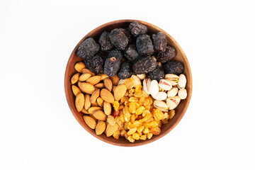 A top down view shows a wooden bowl with four different kinds of mixed nuts.