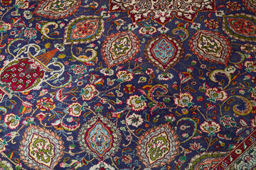 Detail of persian carpet macro: floral blue and red pattern texture
