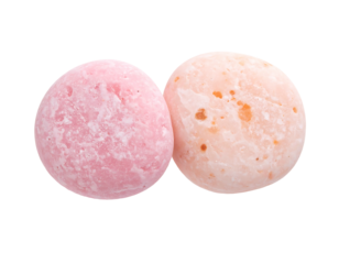 Two round, pastel-colored sweets, one pink, one peach